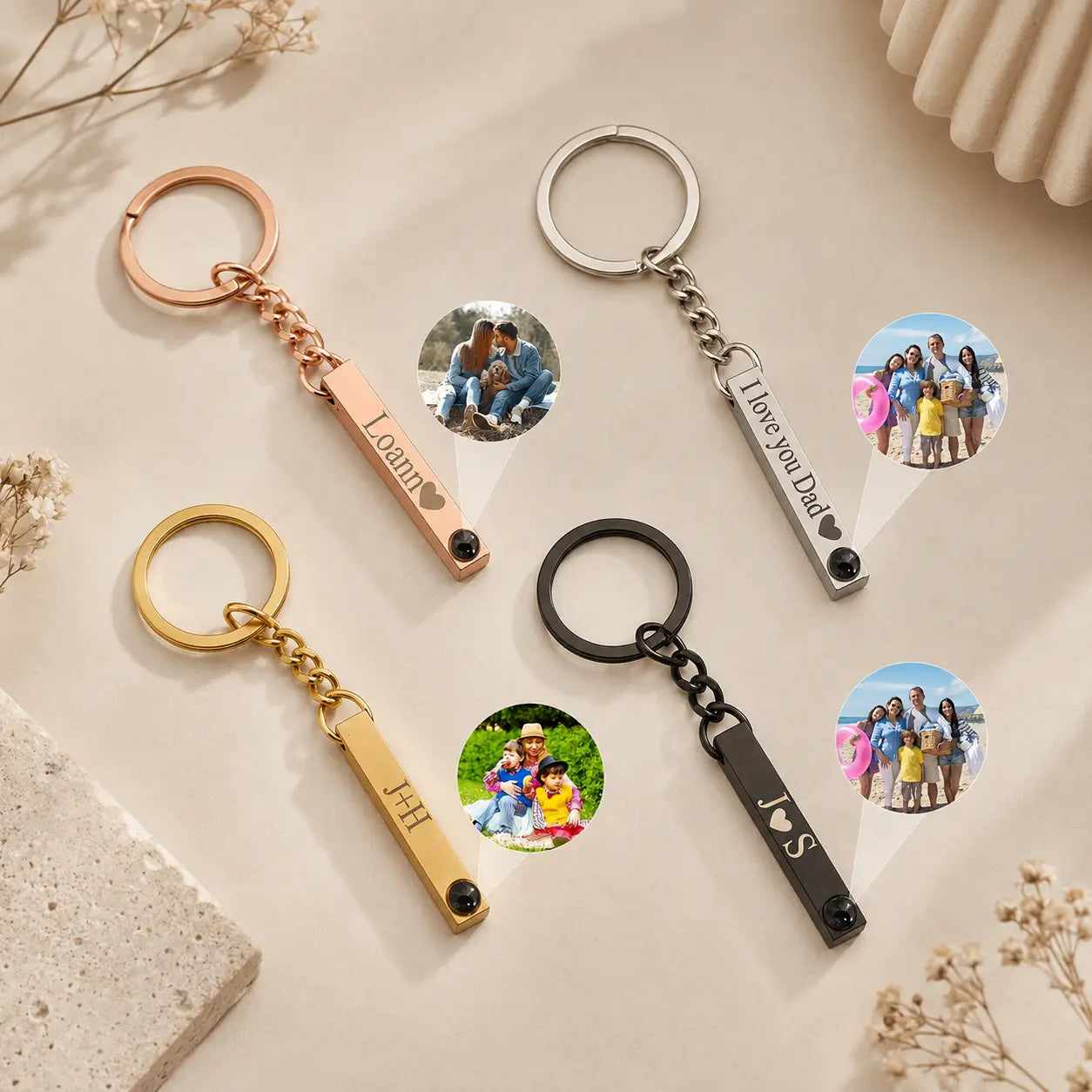 Personalized custom photo projection metal keychains with engraved names and heart symbols in rose gold silver yellow gold and black finishes.
