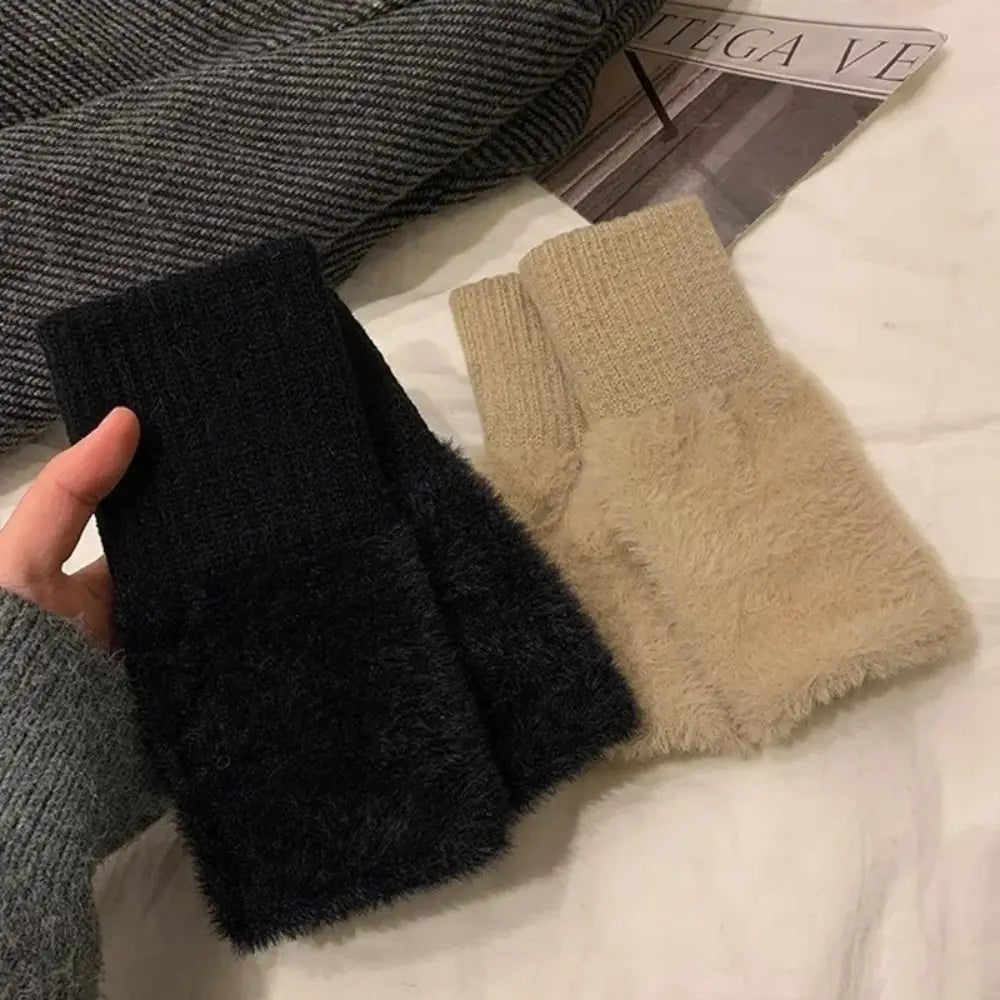 Black and beige fluffy fingerless knit gloves with a soft plush texture designed as wrist warmers.
