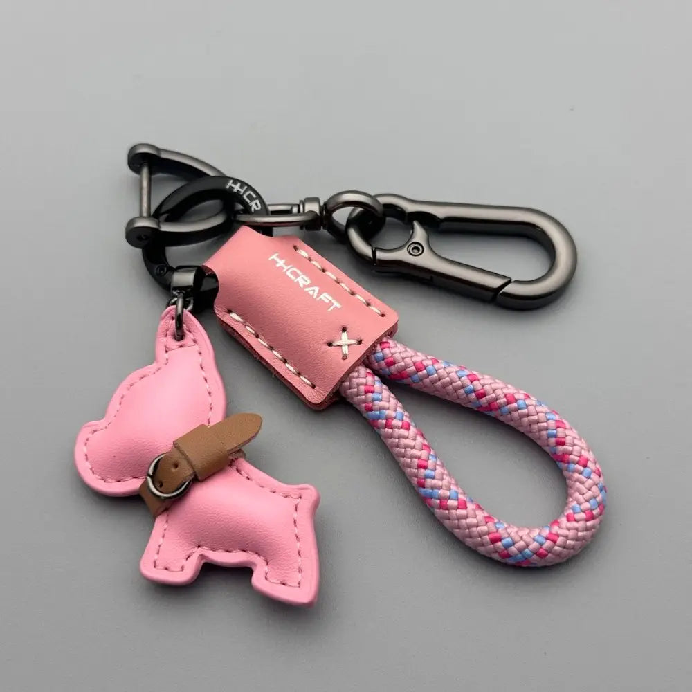 Pink leather French Bulldog keychain with braided pink and blue rope strap and black metal carabiners.