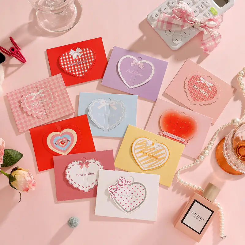 Pastel-colored heart-shaped sticky notes with decorative bows and patterned designs from a 3d heart greeting cards set for Valentine wedding notes.