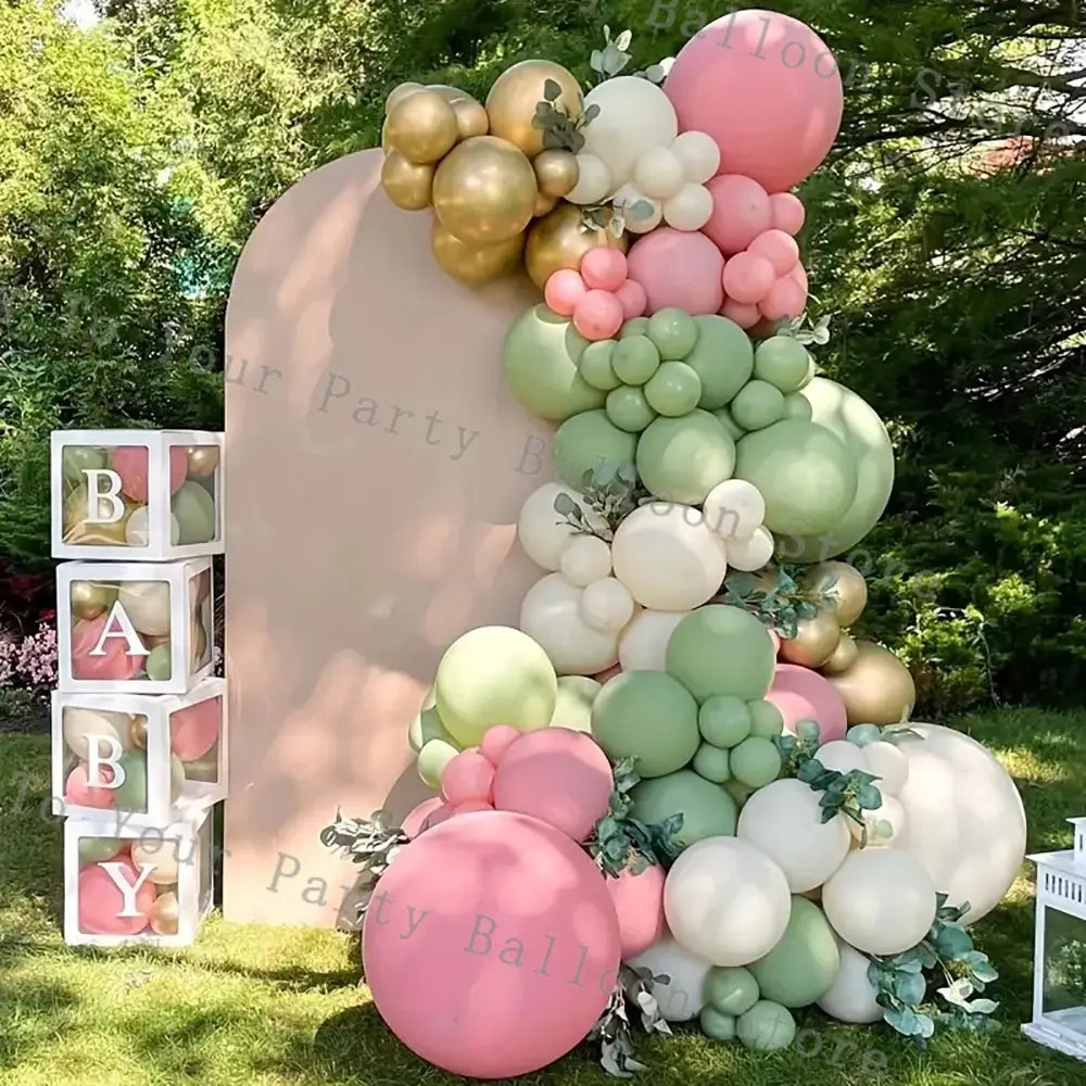 A lush multi-tiered pink balloon arch kit featuring soft pastel shades of pink mint green gold and white with delicate greenery accents perfect for weddings and birthday parties.