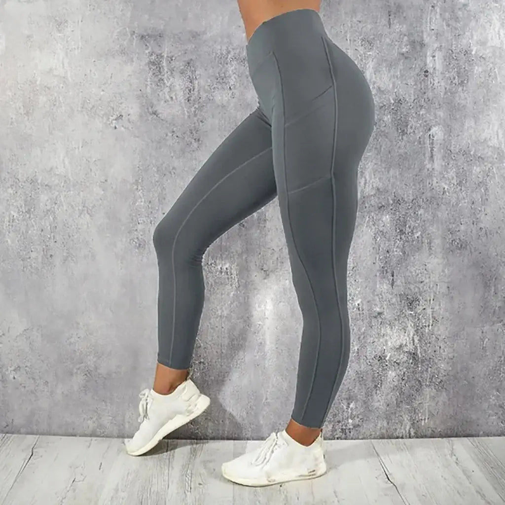 Gray high waist booty lifting pocket leggings with a sleek form-fitting design and subtle side seam detailing.