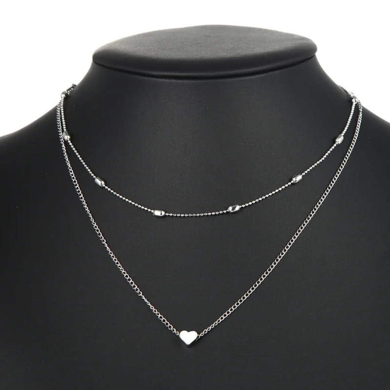 silver double-layered necklace for women featuring delicate alloy jewelry chain links and a small heart pendant designed to avoid contact with chemical substances.