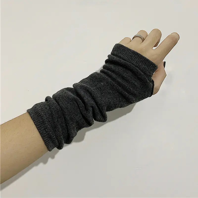 dark gray knitted fingerless wrist warmer with ribbed texture and elastic cuffs as part of striped knit fingerless arm warmers collection