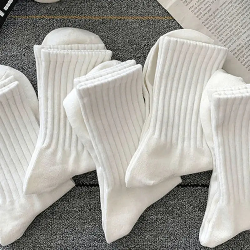 リブ編みのニット素材の白いスポーツソックスで、柔らかなふわふわした質感とクラシックなクルー丈を備え、快適なフィット感を提供します。