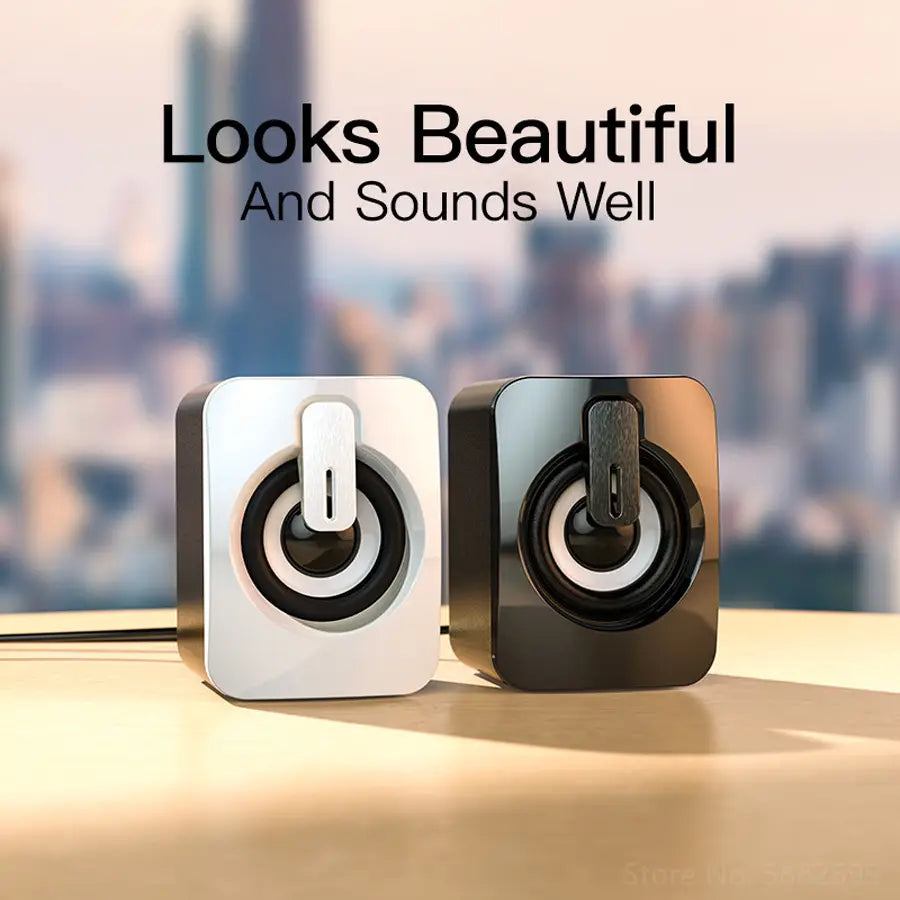 A sleek white and black glossy usb computer speaker with a square shape designed as a stereo desktop mini sound system.