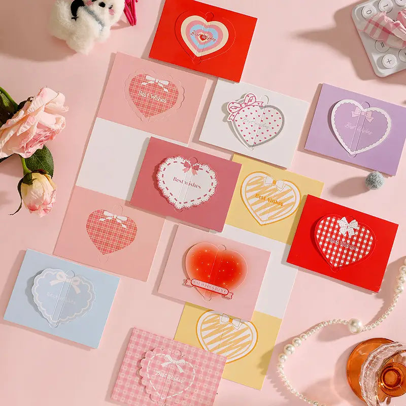 A collection of pastel-colored 3d heart greeting cards featuring delicate lace and ribbon details with best wishes printed in soft script font for valentine and wedding notes.