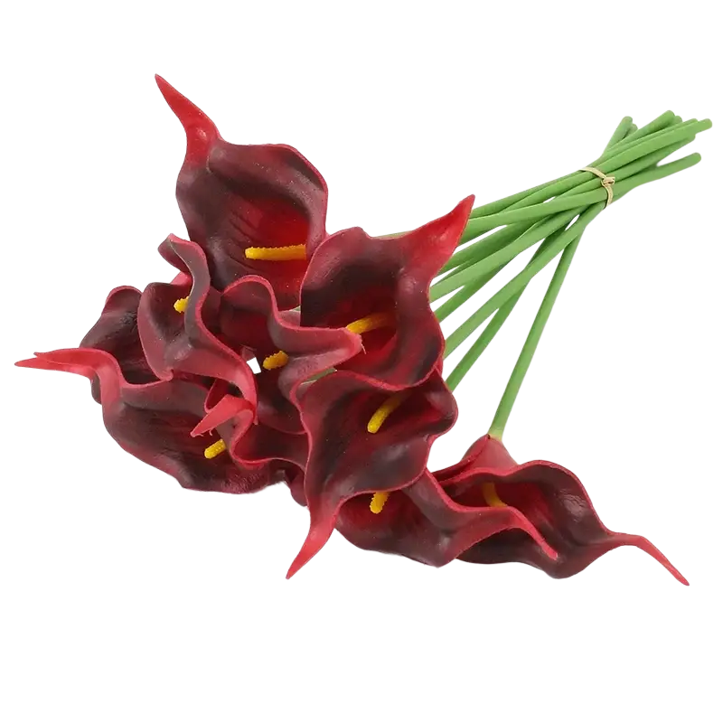 Bunch of artificial red calla lily flowers with green stems and yellow stamens in a flower bouquet arrangement