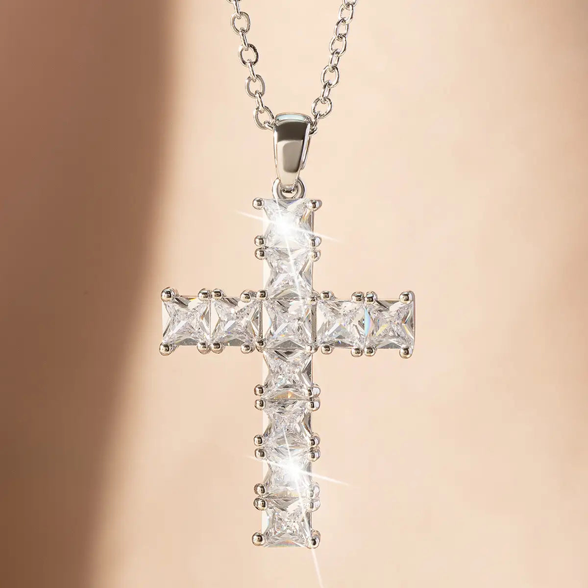 A sparkling silver cross pendant necklace featuring clear faceted princess-cut stones set in polished metal, ideal as fashion necklaces female and necklaces female pendants.