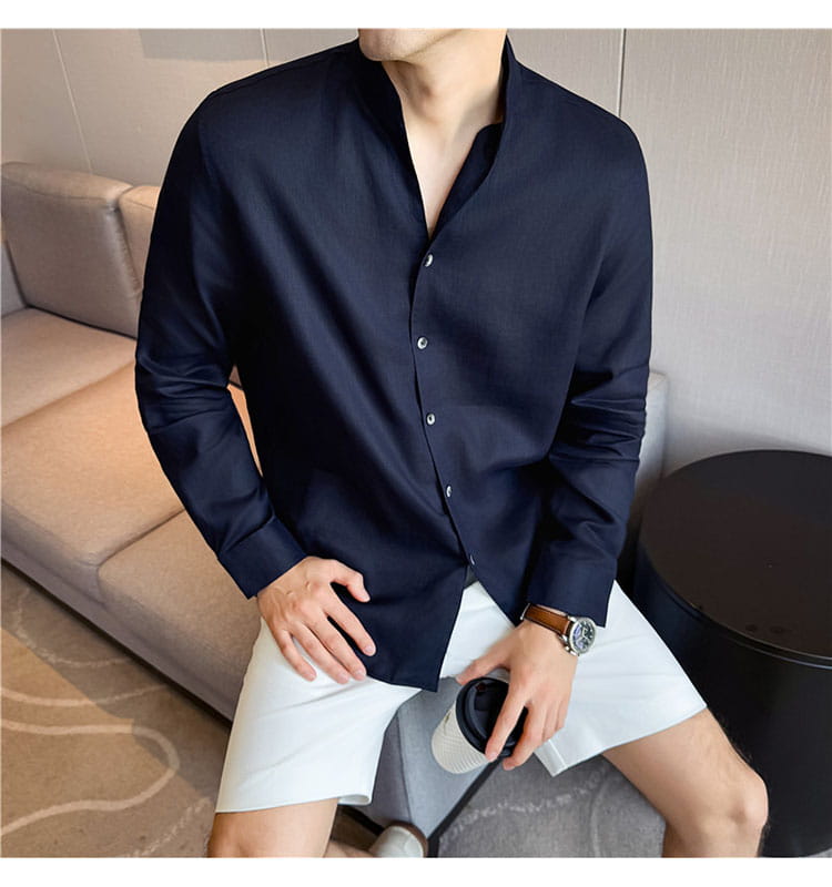 A sleek navy blue men’s linen shirt with long sleeves and a modern mandarin collar featuring subtle creases.