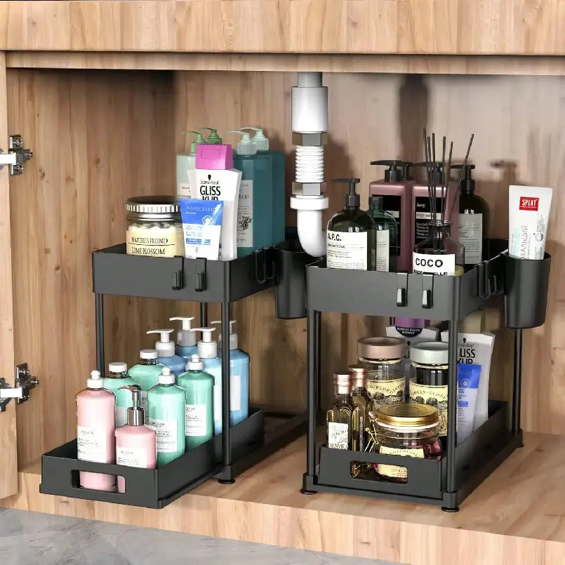 Black two-tiered sliding under sink organizer made of bpa-free plastic with side compartments and hooks for efficient storage.