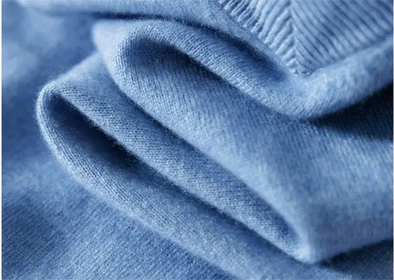 Men cashmere v neck pullover sweater in soft light blue knit with ribbed neckline and smooth texture.