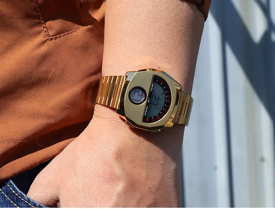 Megir men stainless steel digital watch featuring a gold-toned rectangular face with red-accented bezel and dual display screens.