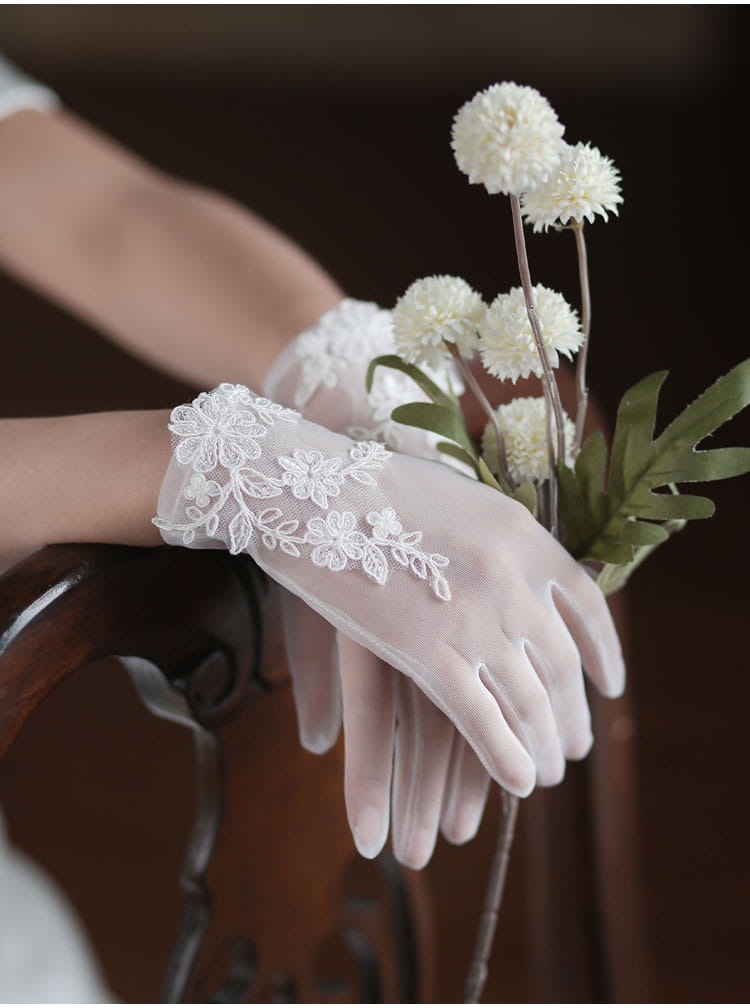 white lace bridal gloves with delicate floral embroidery featuring short tulle applique for wedding use