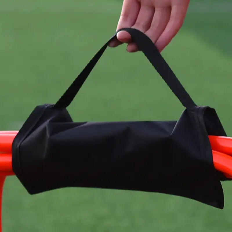 black fabric soccer agility hurdle carrying strap and storage bag with adjustable strap designed to hold orange training cones