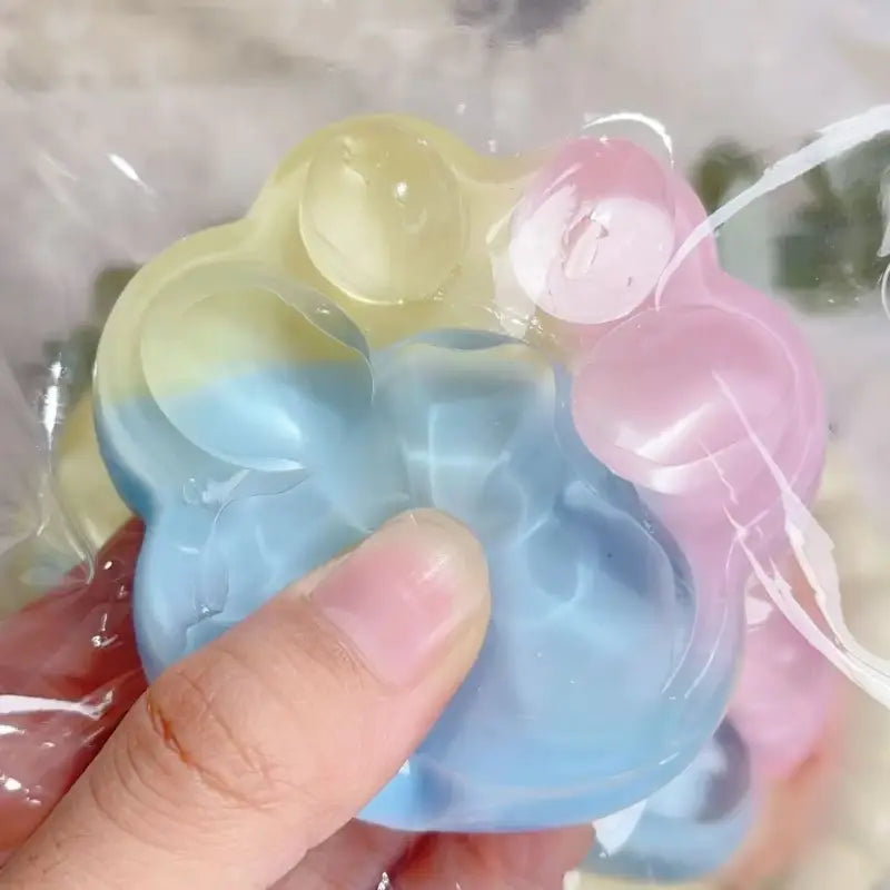 Jouet anti-stress pop-it en silicone pastel et translucide, en forme de nuage, avec une texture souple et moelleuse, appelé jouet anti-stress souple et moelleux en griffe de chat arc-en-ciel.