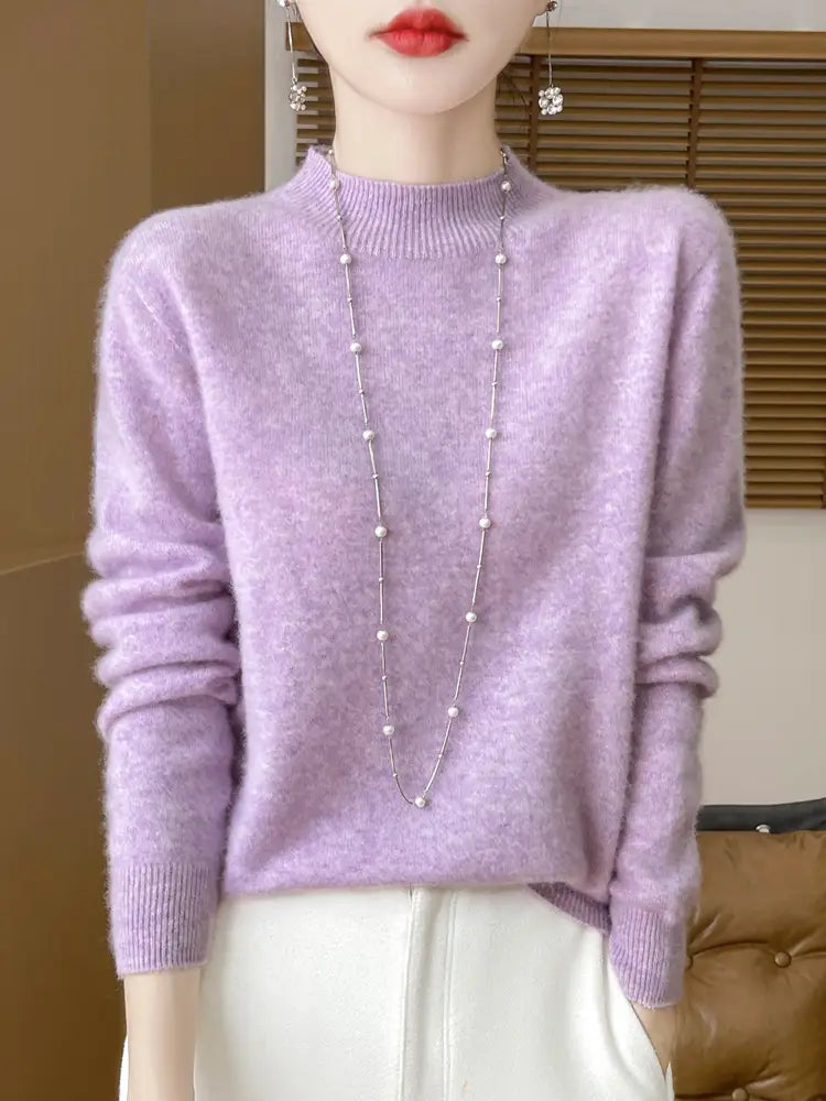 A soft lavender merino wool pullover sweater for women with a high neckline long sleeves and a subtle textured pattern.