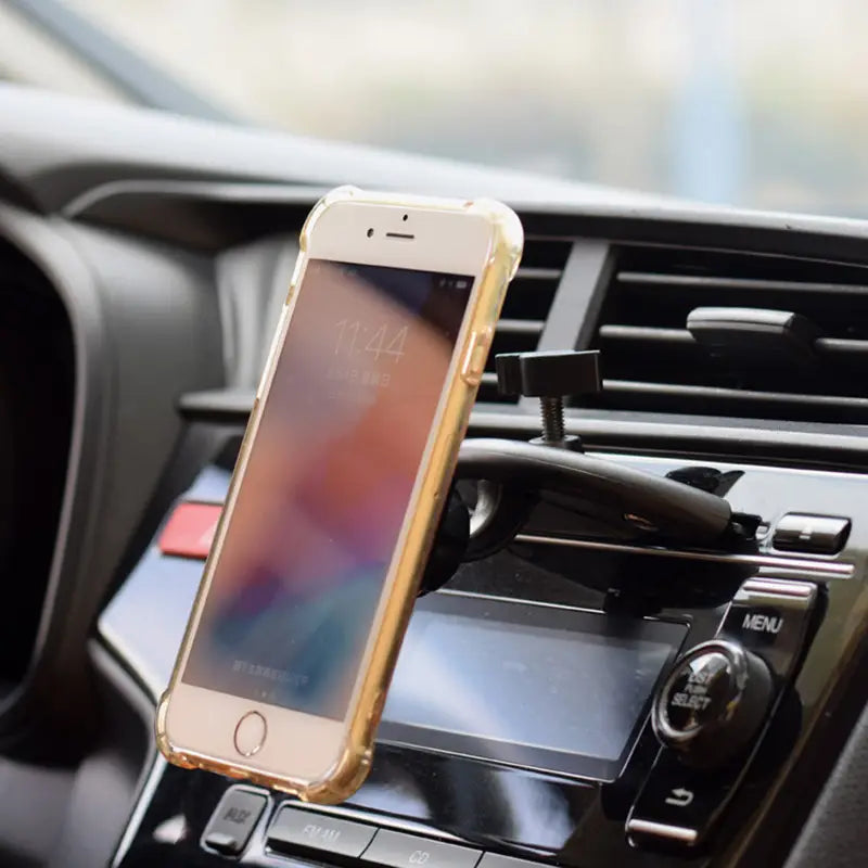 gold-colored magnetic cd slot car phone mount securely holding a white iphone with a clear protective case designed for gps and mini devices.