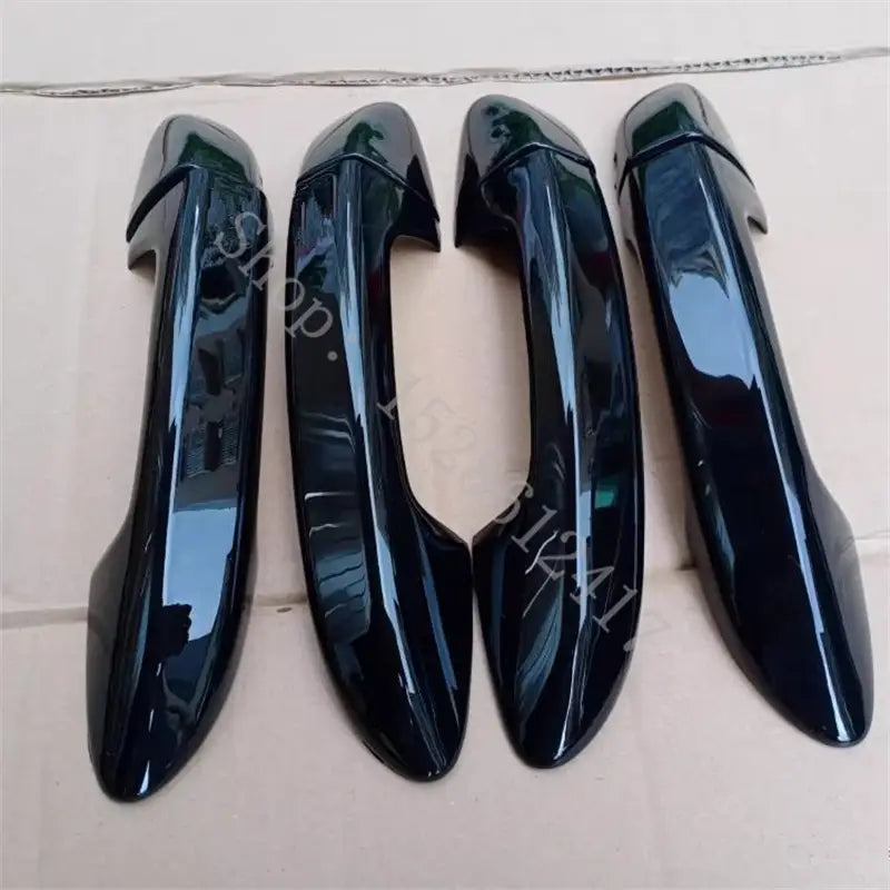 four glossy black plastic vw passat door handle cover trims with carbon fiber design designed to fit specific vehicle models