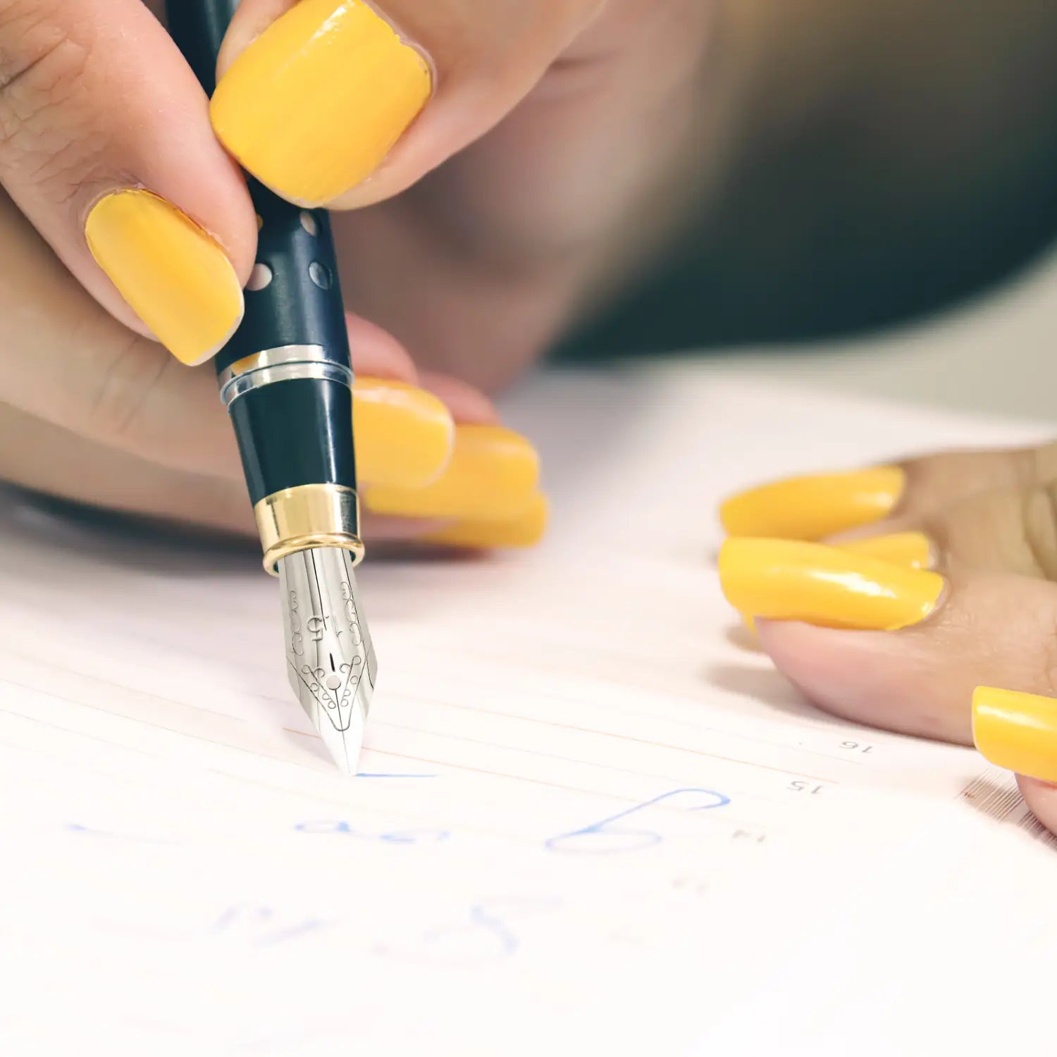 A sleek black stainless steel fountain pen nib set with gold accents and a silver nib featuring an elegant design.