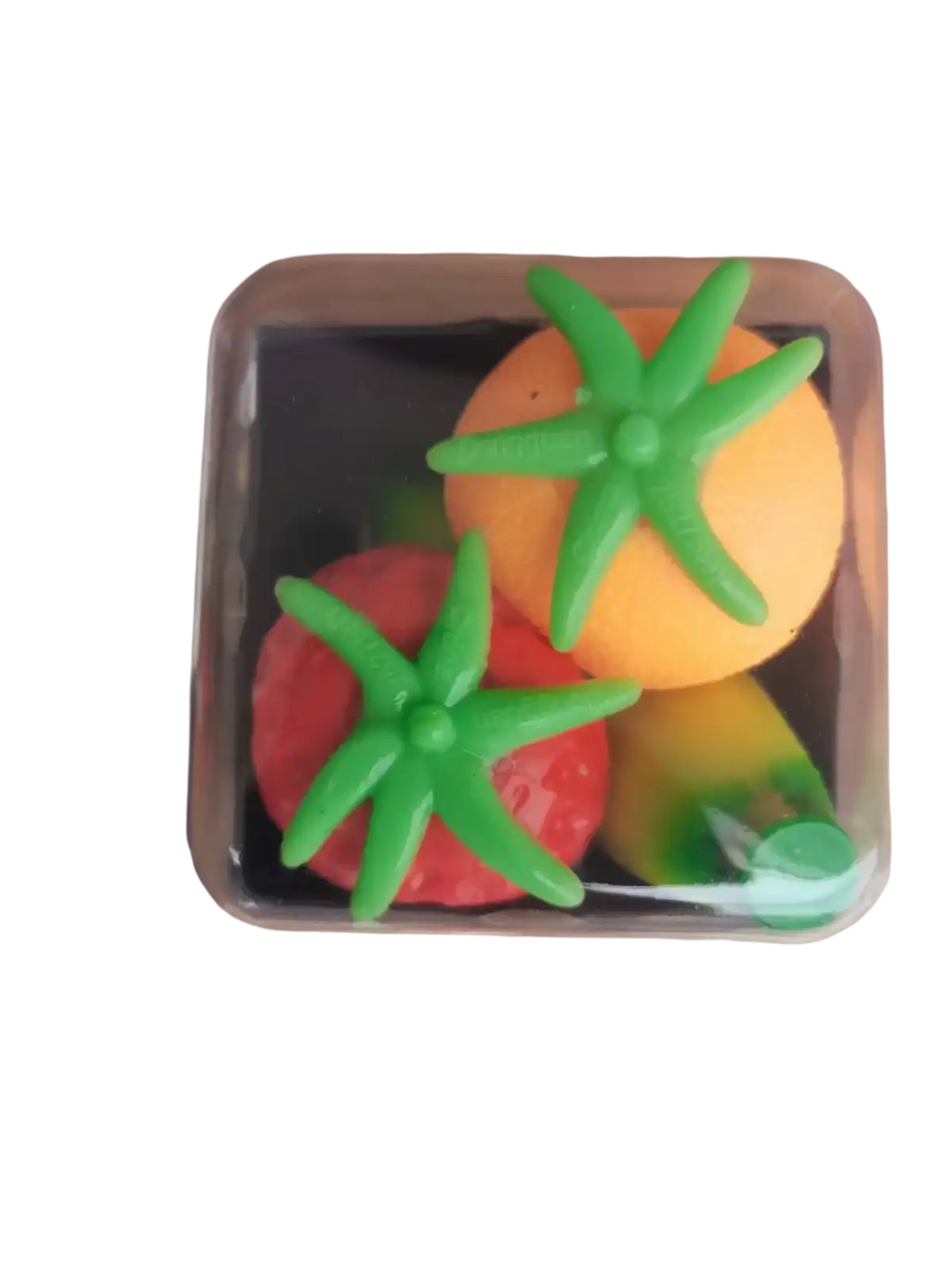 A clear plastic container holds colorful silicone tomato-shaped stress balls with green tops for stress relief use