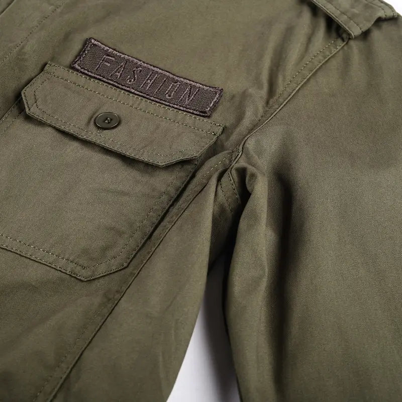 Men cotton casual long sleeve olive green utility jacket with a brown fashion patch and buttoned chest pocket, styled as a military cargo shirt.