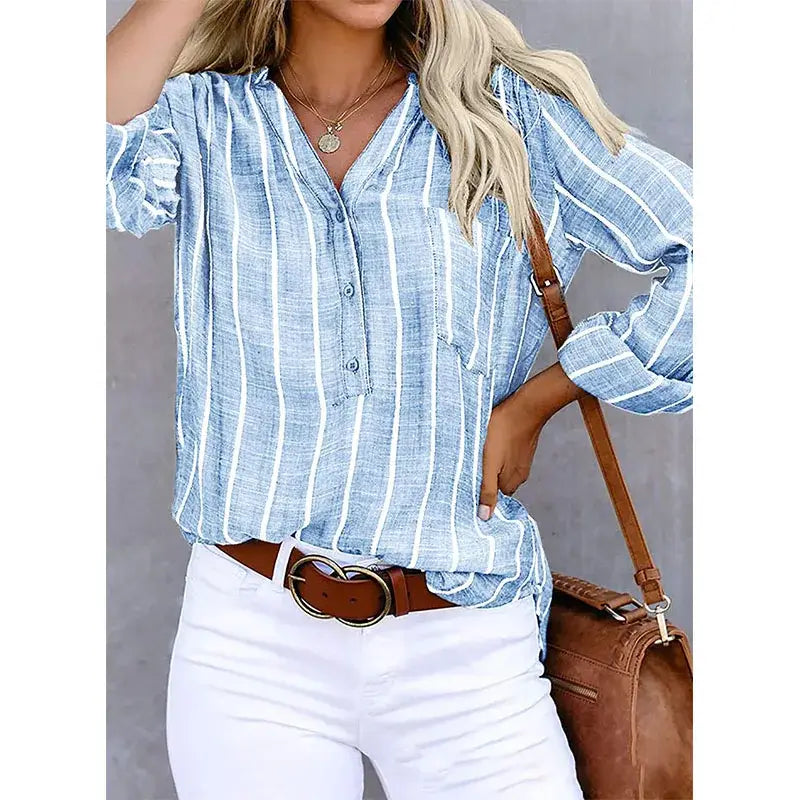 Light blue and white vertically striped button up shirt for women with ruffled cuffs made from cotton polyester fabric sourced from mainland China.