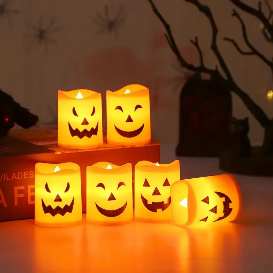Set of six glowing orange LED jack-o-lantern candles showcasing carved facial expressions for Halloween decoration.