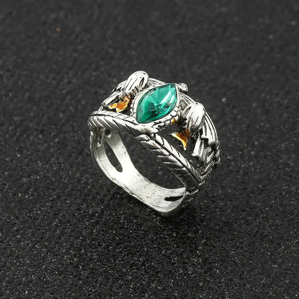Silver lord ring of barahir featuring an intricate dragon design with a central emerald green crystal and gold accents for cosplay use.