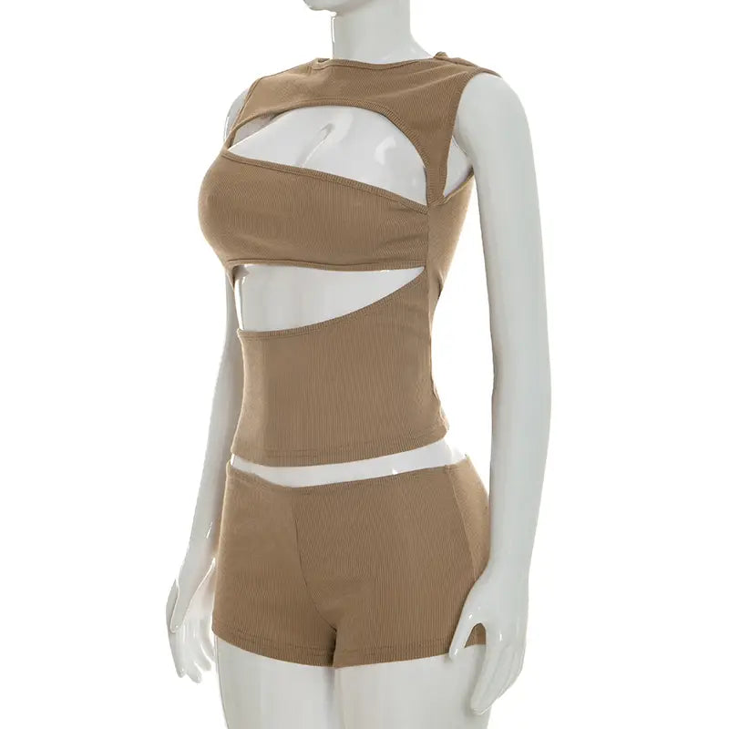Tan ribbed knit two-piece set featuring bold geometric cutouts including a tank top and shorts.