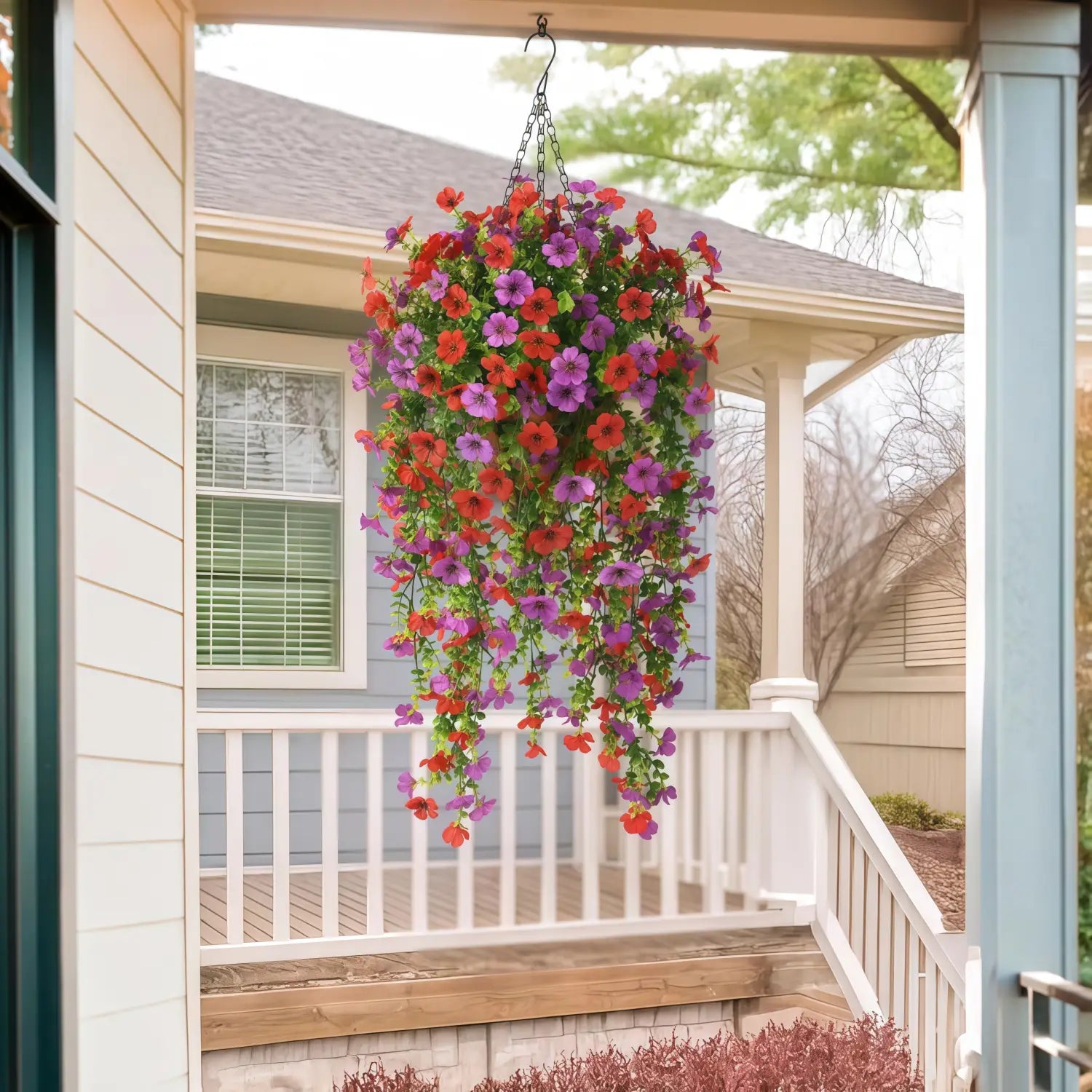a vibrant artificial flower bouquet featuring cascading red and purple petunias hanging from a porch ceiling, complemented by morning glory vines and eucalyptus elements