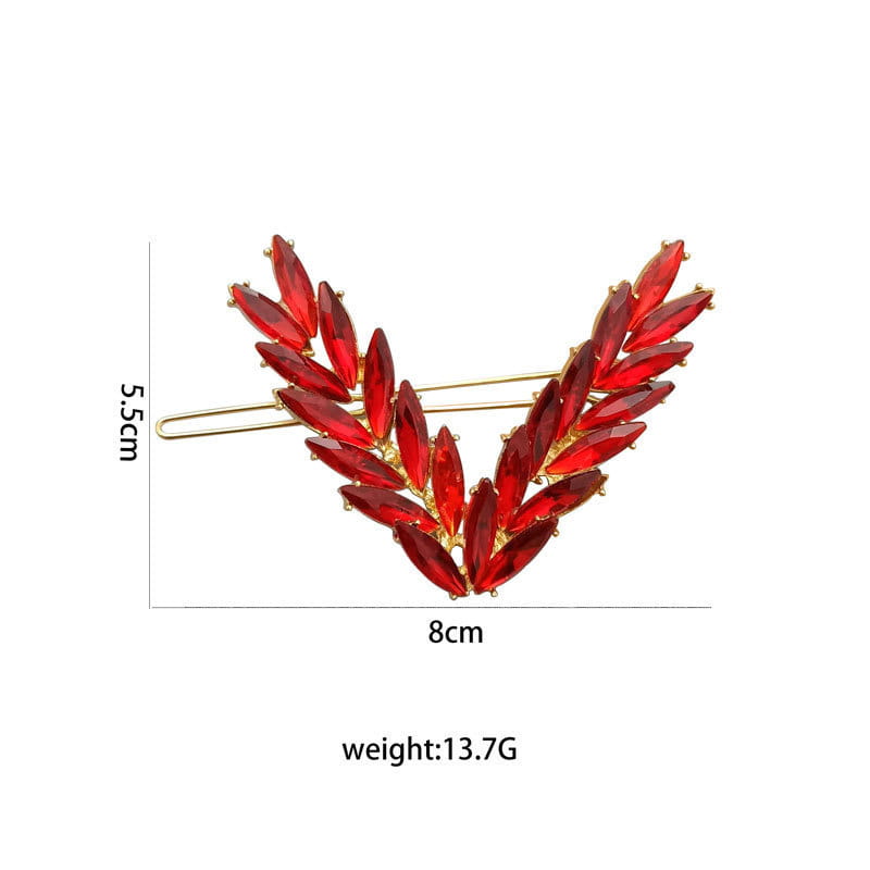 A decorative red crystal leaf hair clip with a gold-tone metal base from the crystal v shape hair clip set.