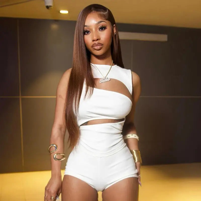white cut-out sleeveless top with a fitted design paired with high-waisted black ribbed knit shorts in a tank top and shorts set.