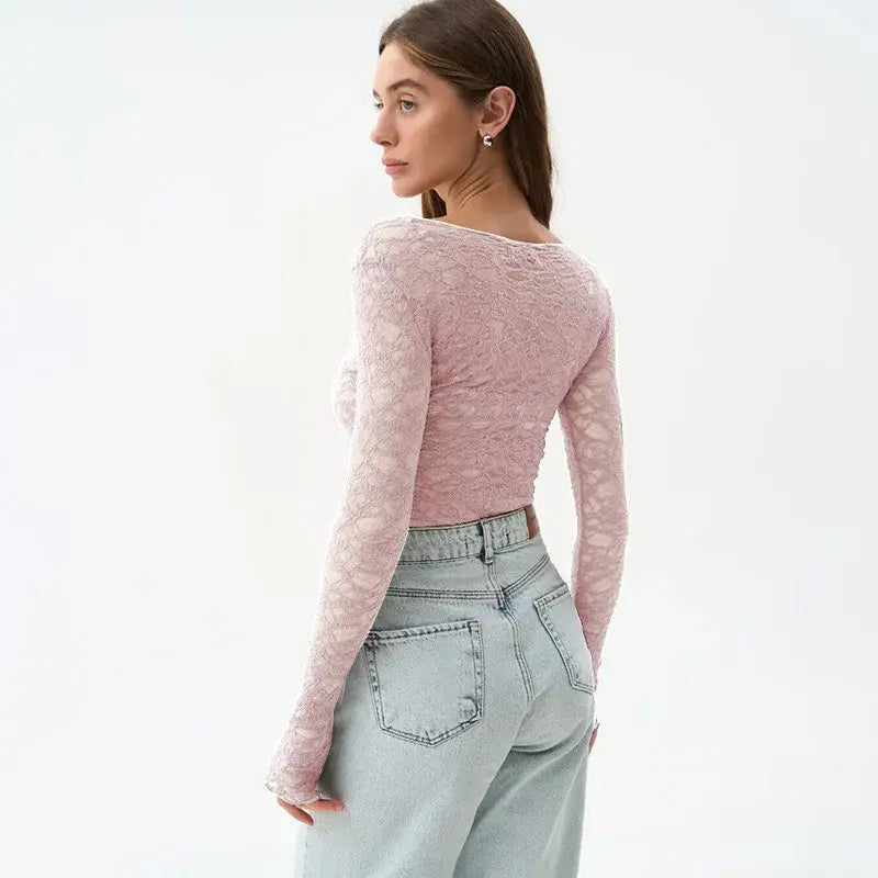 A delicate pink lace long-sleeved crop top for women aesthetic clothes featuring a fitted ruched back and subtle floral pattern.