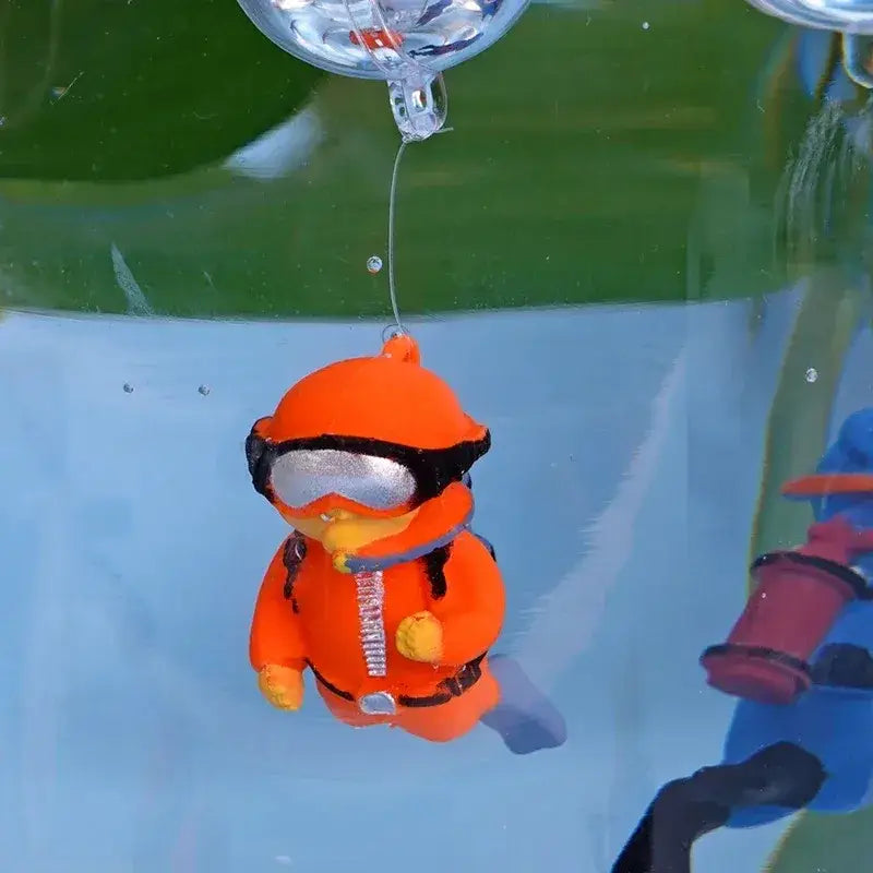 Orange plastic diver figurine with black goggles and silver accents as a popular aquarium decoration for fish tanks and aquatic pet landscape decor accessories.