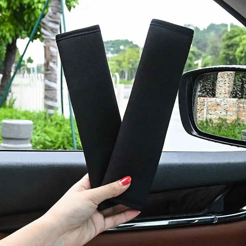 black plush fabric car seat belt cover designed as a shoulder pad for added comfort and support
