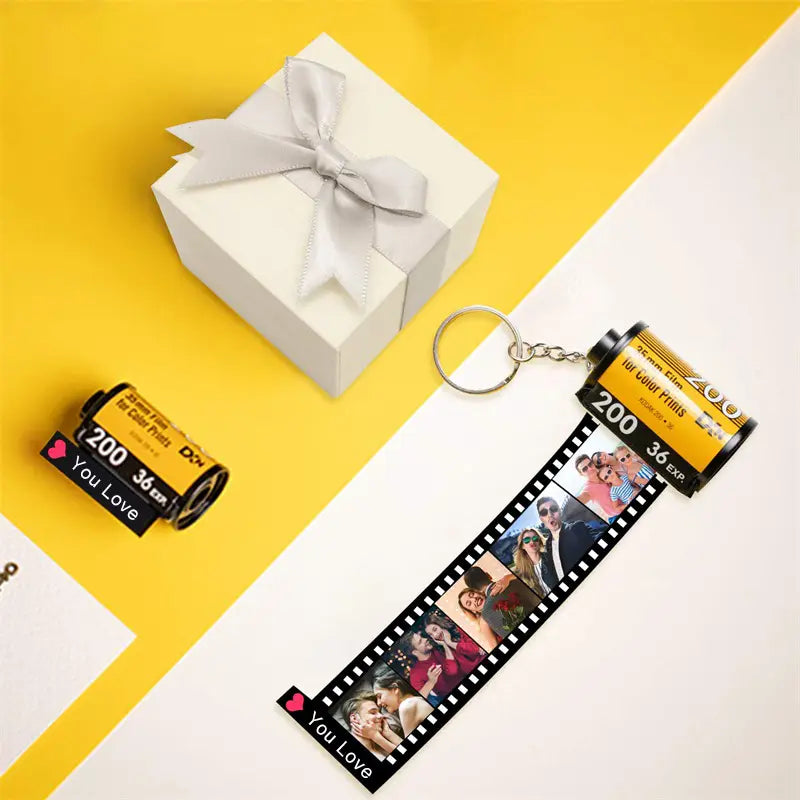 Custom photo film roll keychain in yellow and black featuring printed photos of a couple and you love text on the end.