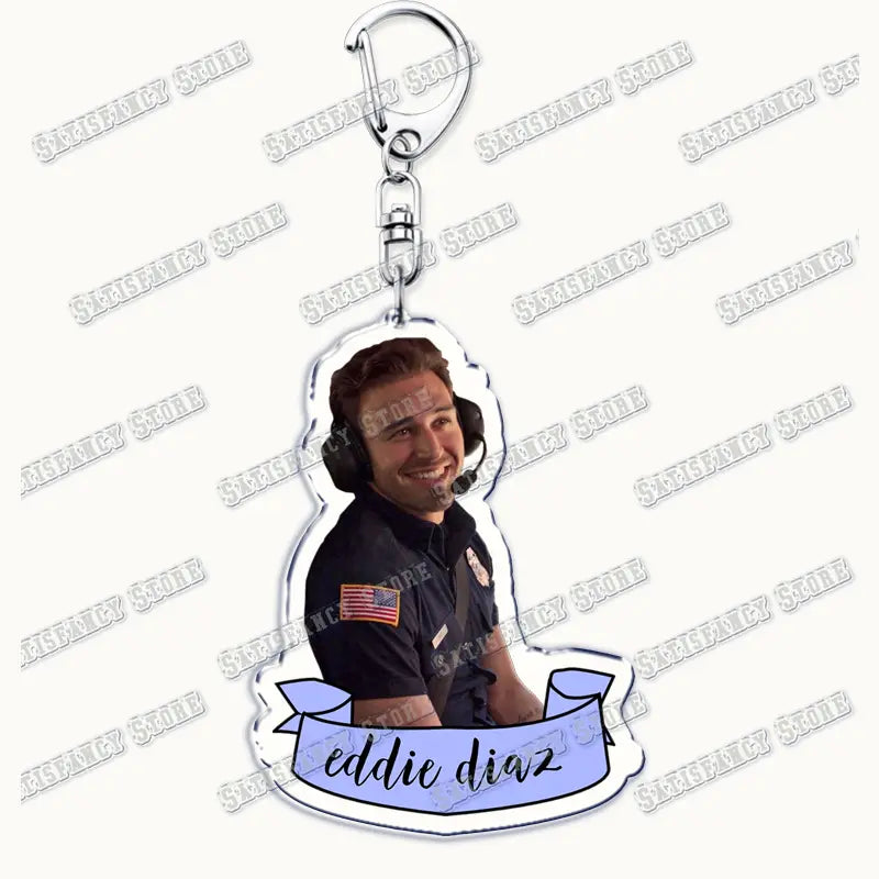 clear acrylic keychain featuring a smiling man in a black uniform with american flag patch and headset labeled eddie diaz on a light blue banner from 9-1-1 tv show firefighter gift