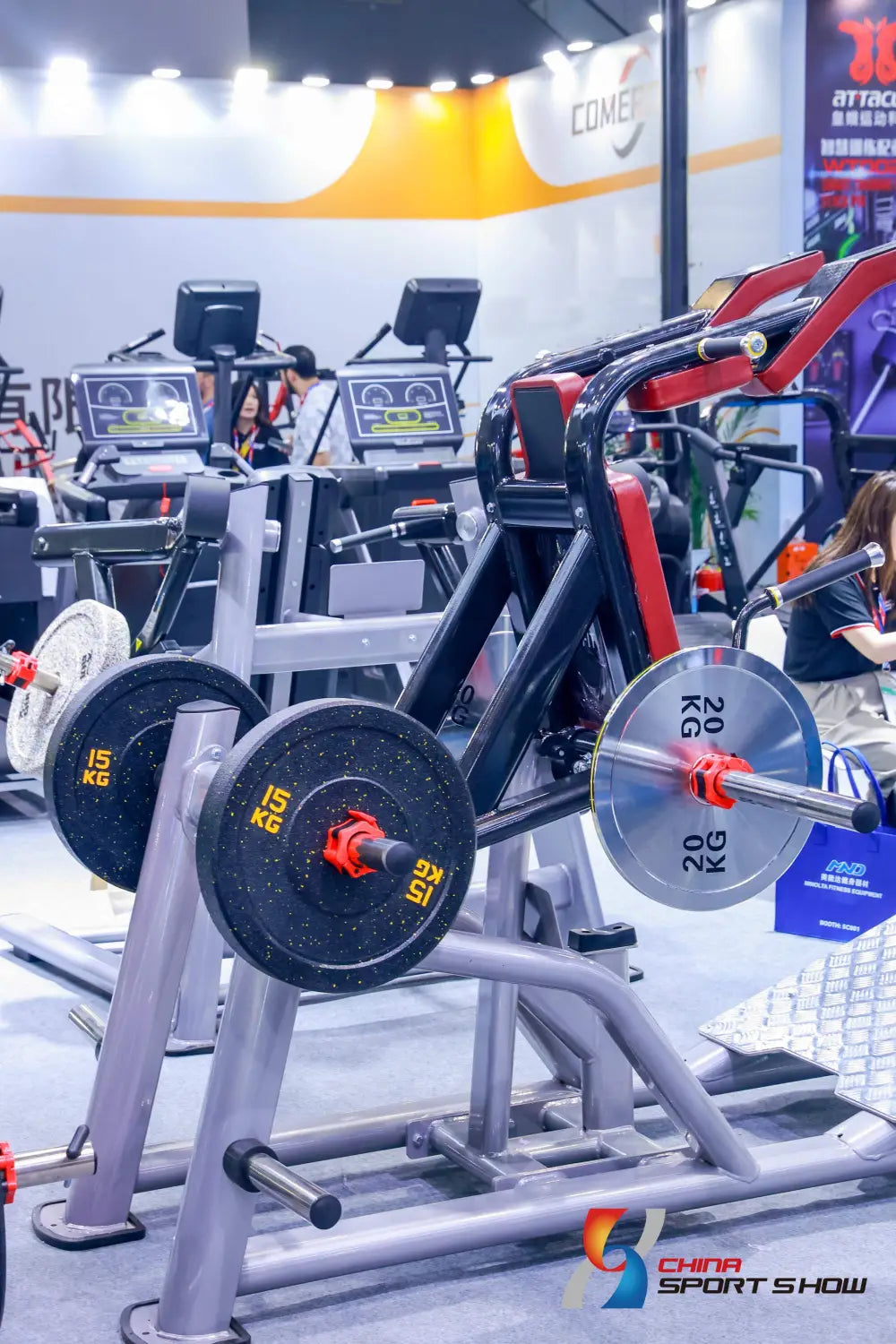 black and red weight plates with yellow numerical markings mounted on a silver metal commercial stair climber machine cardio stepmill