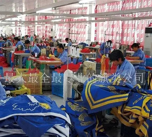 Blau-gelbe Sporttrikots mit bestickten Logos, die auf Montagebändern für die Herstellung eines Deutschland-Flaggenprodukts mit Stangenhülse genäht werden.