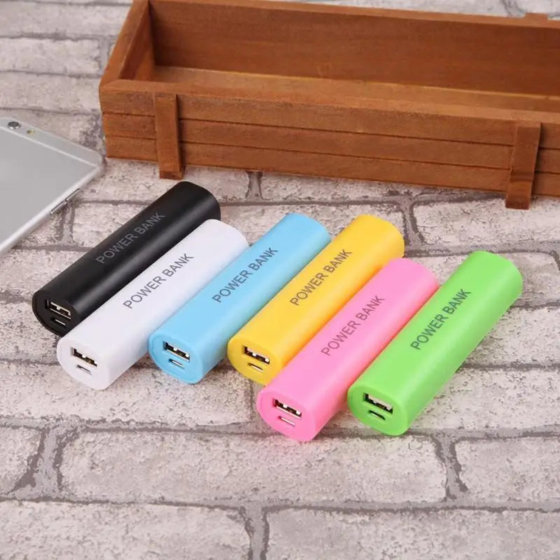 A set of colorful cylindrical portable 18650 power bank cases in black white blue yellow pink and green with power bank printed on each designed for diy shell charger use.