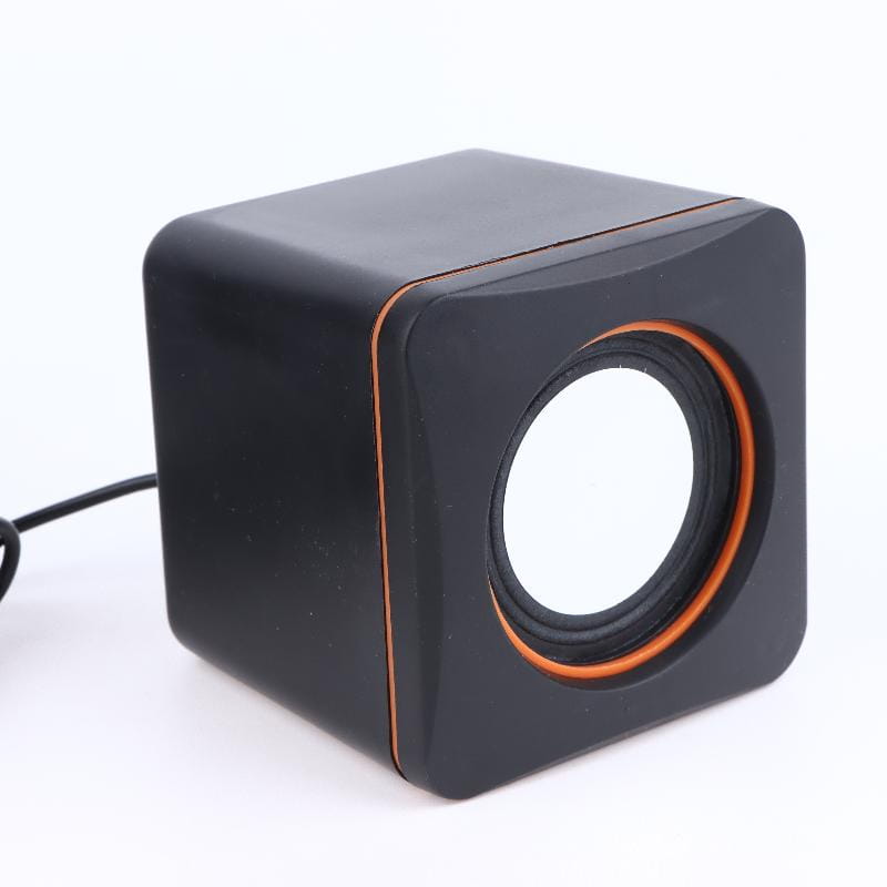 Black cube-shaped usb computer speaker with led stereo audio and orange trim around the circular driver for desktop pc use.
