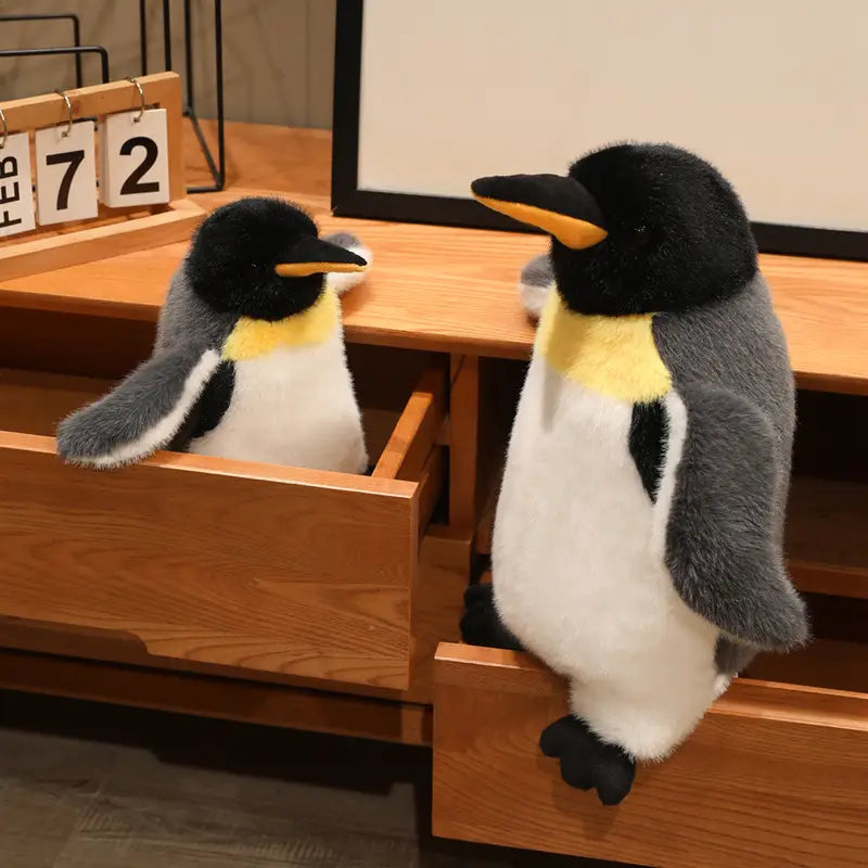 Soft plush emperor penguin stuffed animal soft toy pair featuring black heads, yellow necks, and gray wings.