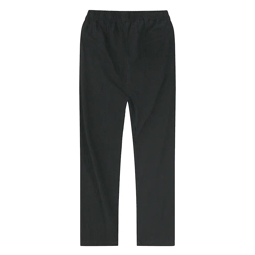 Black cotton linen trousers with breathable fabric and an elastic waist featuring a smooth straight-leg cut for casual wear