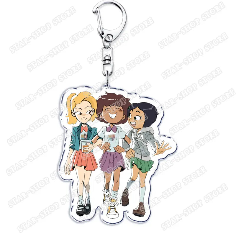 Clear acrylic Amphibia anime keychain featuring three animated girls in colorful school uniforms with distinct hair colors and outfits.