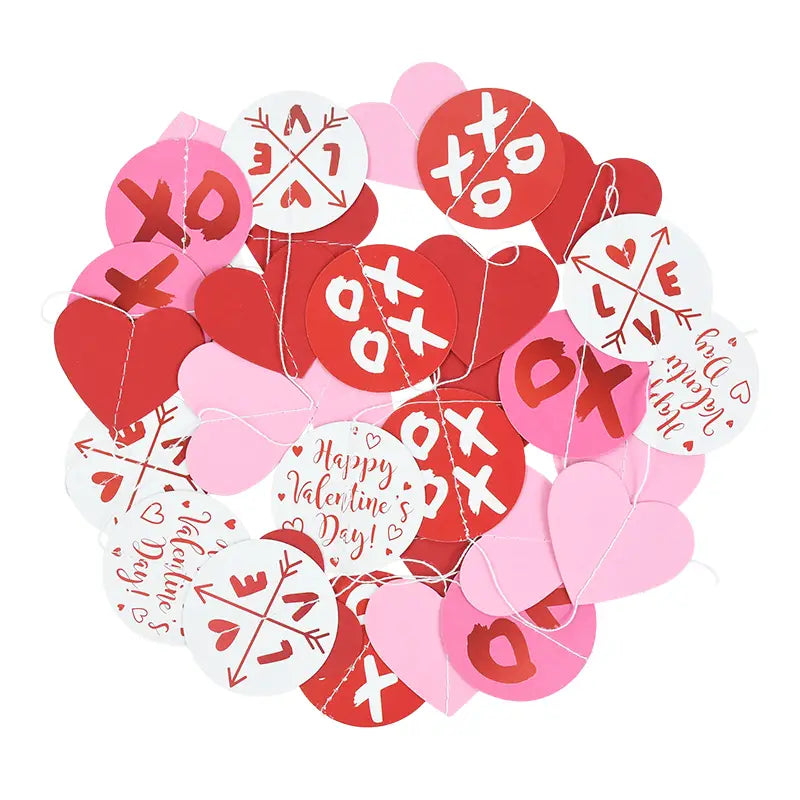 Guirnalda de corazones para San Valentín: pancarta con recortes de papel en rojo, rosa y blanco en formas de corazón y circulares, con diseños xo y texto «happy valentines day» para decoración festiva.