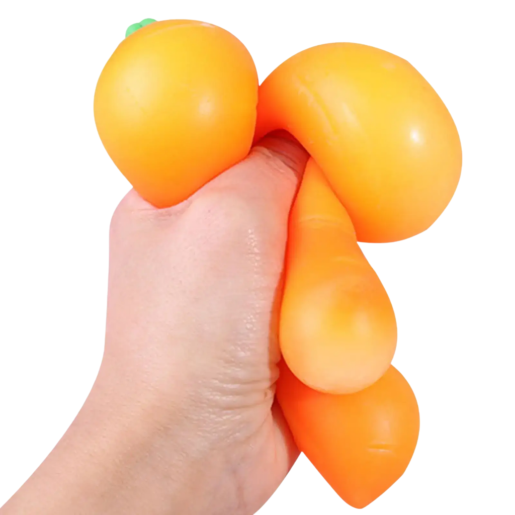 Front view of an orange carrot shaped slow rebound squeeze toy with a green leafy top