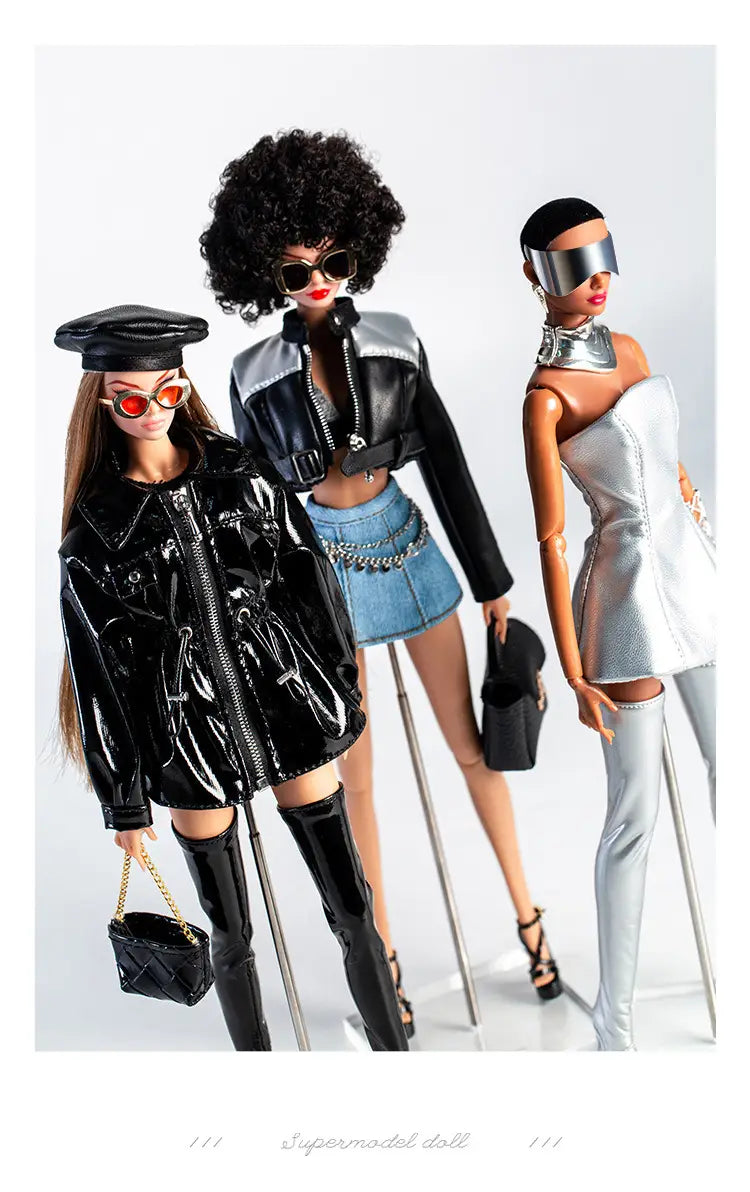 three fashion-forward barbie dolls wearing futuristic retro doll outfits for 30cm 1/6 models featuring a glossy black trench coat and boots, a leather jacket with a denim skirt, and a metallic silver bodysuit.