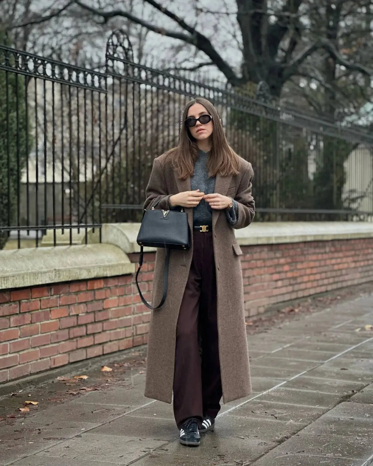 black leather handbag with gold-tone logo clasp paired with a brown wool blend overcoat for women winter commuter jacket