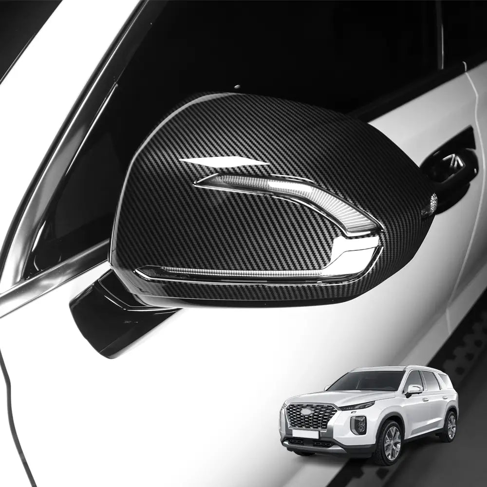 Black carbon fiber textured side mirror cover with sleek glossy finish and integrated led lighting strip for Hyundai Palisade led mirror covers 2020-2025.